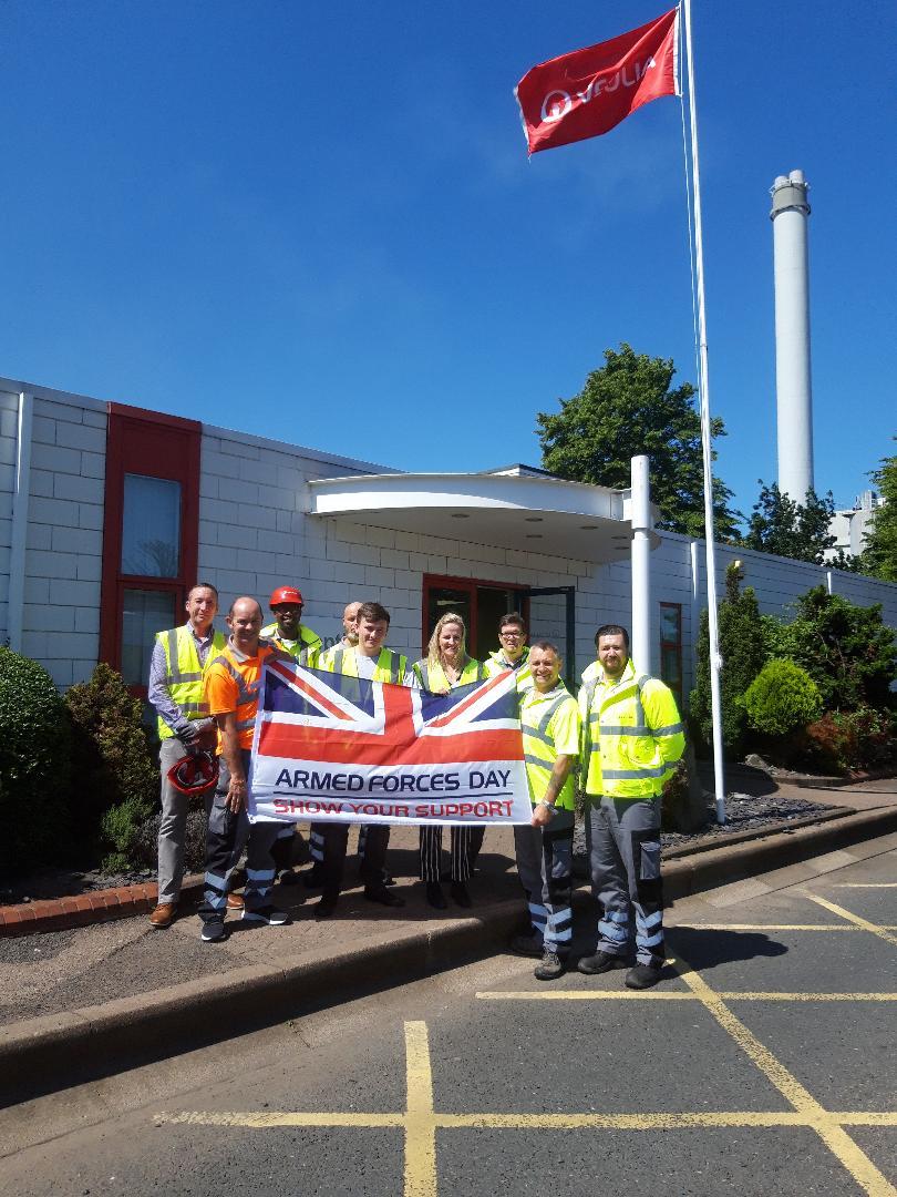 Members of the Veterans' Insight Day raise the Armed Forces Flag