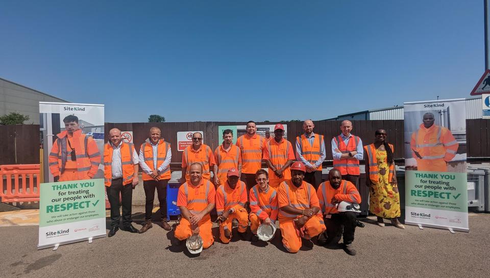 Veolia frontline staff and managers stand with the local Councillor between SiteKind campaign banners