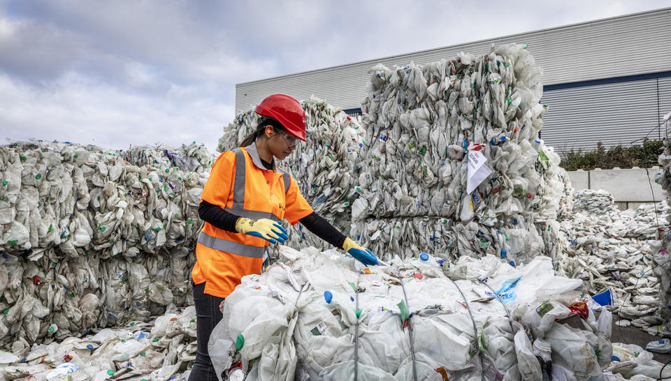 Worker recycling plastics