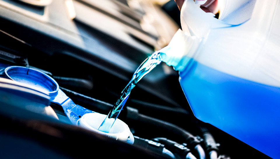 Screen wash being poured into a car