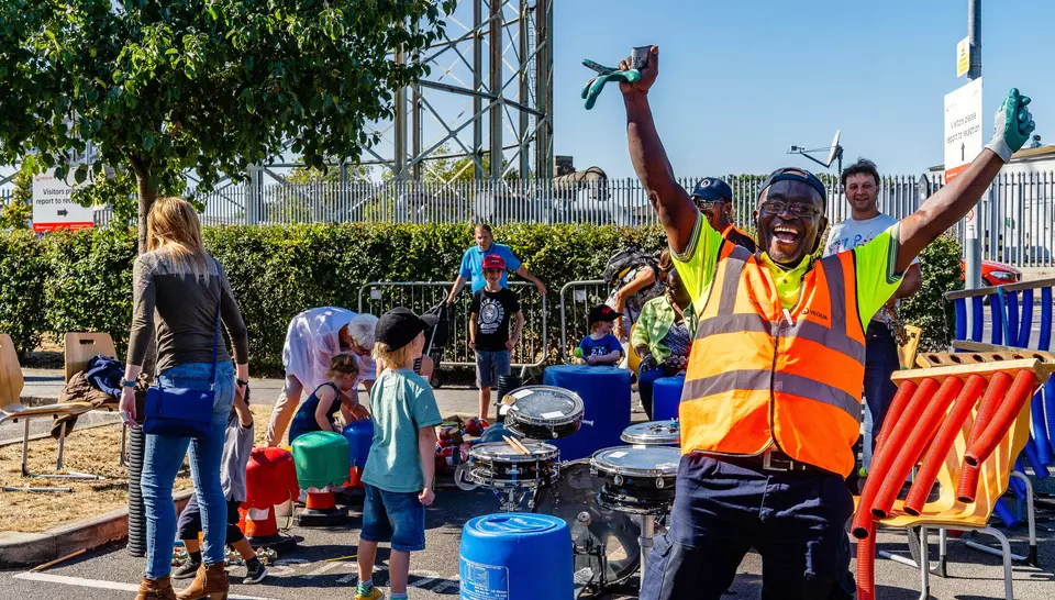 A Veolia operative throws his arms into the air and cheers
