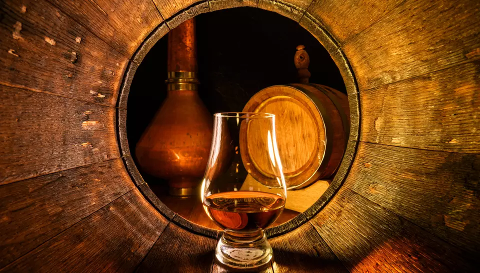 Scotch whiskey glass inside a barrel