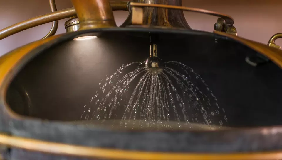 Water spraying on baileys inside a still at a brewery plant