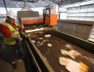 Veolia employee processing waste material