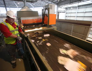Veolia employee processing waste material