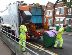 Two Veolia employees placing bins in lorry