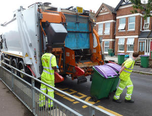 Two Veolia employees placing bins in lorry
