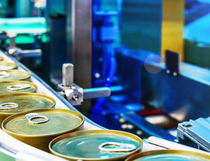 Food cans on conveyor belt during manufacturing process