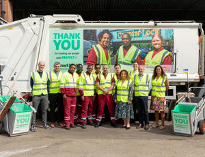 The Camden frontline team and Senior Managers stand together in high vis in front of a collection vehicle with a StreetKind banner