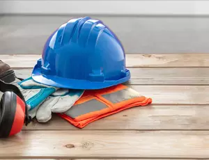 work clothes folded up on the floor 