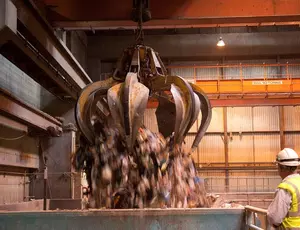 Large claw grabbing recycling waste