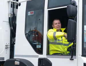 Male veolia waste truck driver