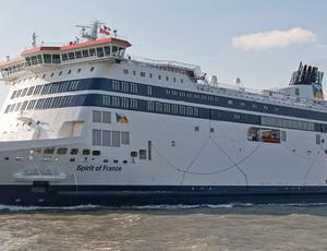 big cruise ship in a green merky sea 