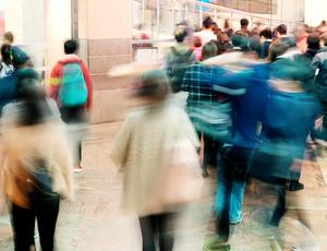 blurred photo of people moving round on a street 