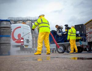 men pressure washing 