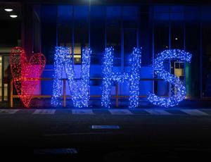 lit up NHS sign 