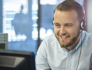 man with headphones on in a work environment 