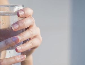 holding glass of water 