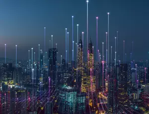 view of city sky scrapers lit up by lights 