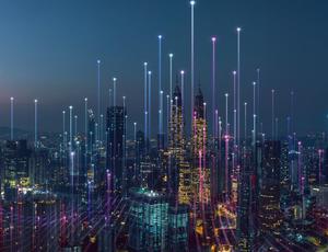 view of city sky scrapers lit up by lights 