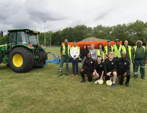 team photo in front of tractor 