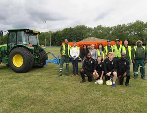 team photo in front of tractor 