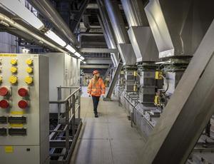 Veolia facility with young lady worker on site in a high visability PPE