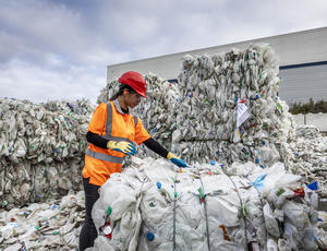 Worker recycling plastics