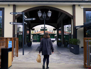 A woman walks into the McArthurGlen designer outlet.