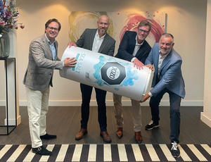 The JOZO and CIRCPACK teams hold up a large prop in the shape of a salt shaker.