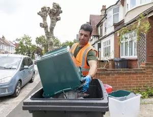 Veolia staff emptying bin