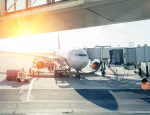 airplane loading in airport at sunset