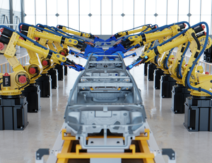 A photo of mechanical arms constructing a car in a factory.