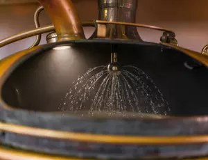 Water spraying on baileys inside a still at a brewery plant