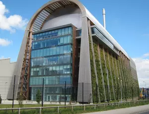 Photo of the Leeds Energy Recovery Facility with a glass facade and green wall running down the full length of the building.