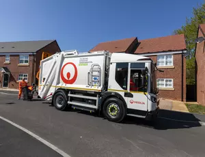 Veolia workers emptying waste from houses with a bin lorry