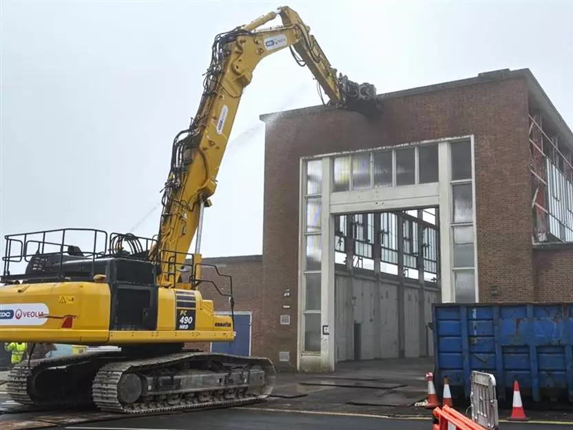 Machinery demolishing building 