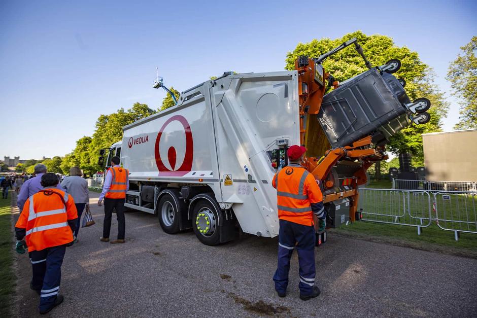 bin men loading up bins to the back of the lorry 