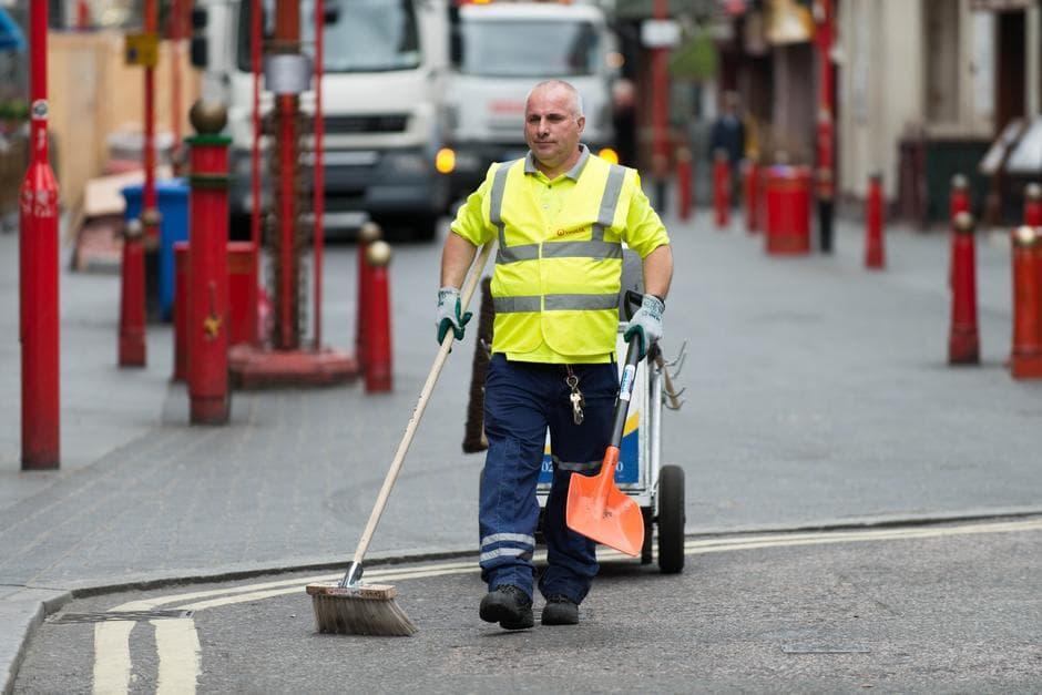 man sweeping the streets 