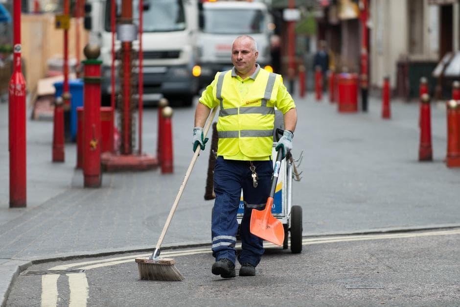man sweeping the streets