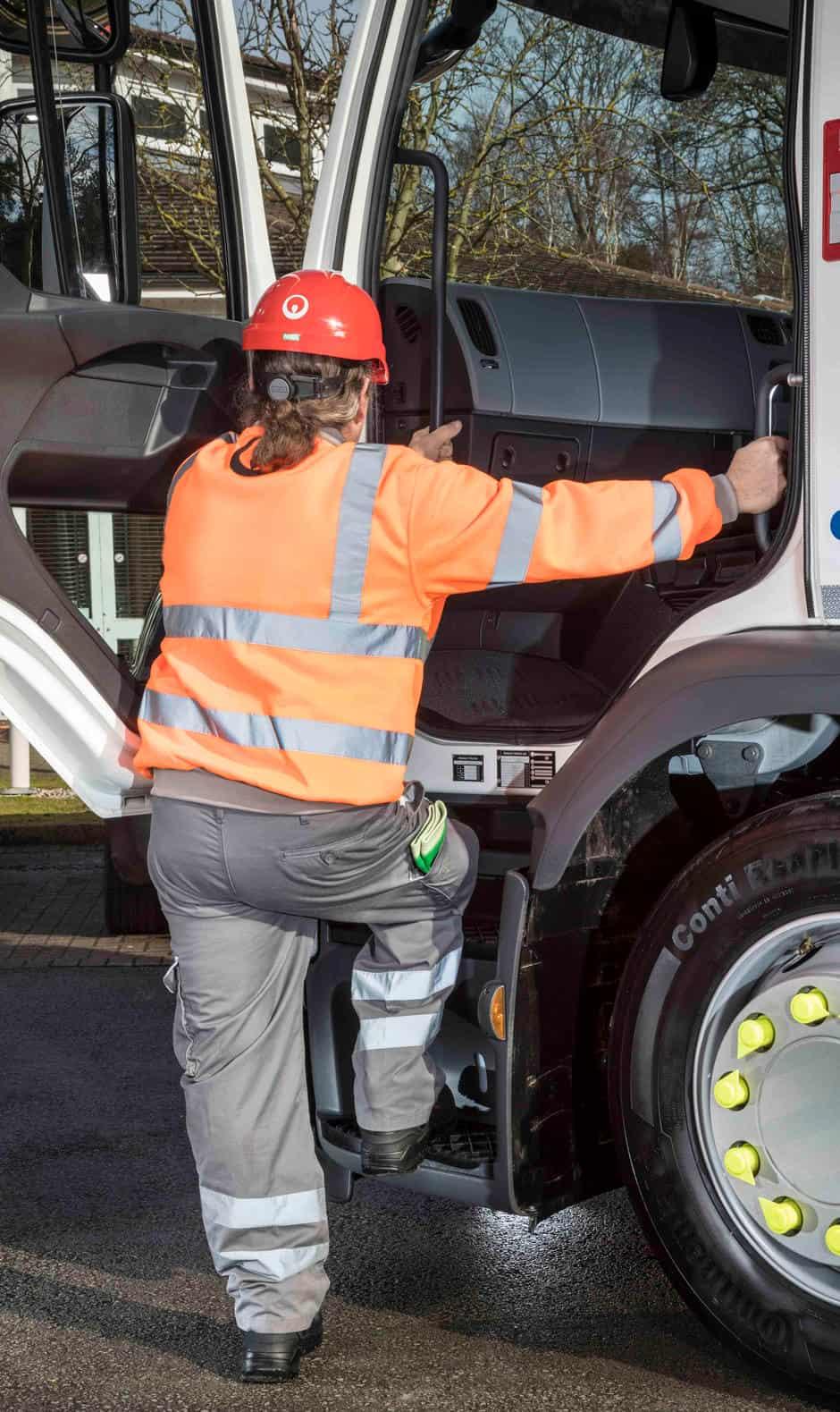 woman getting into lorry