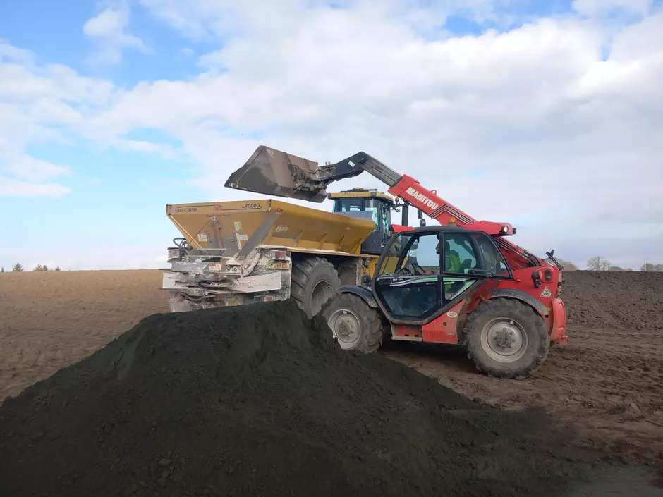 Tractor being loaded with basalt dust