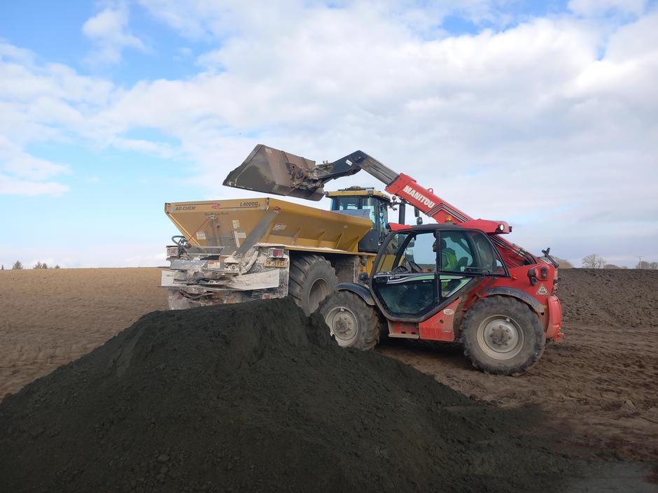Tractor being loaded with basalt dust