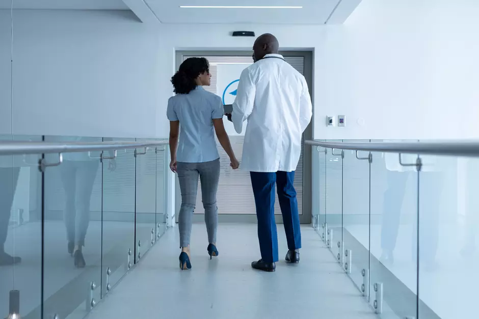 hospital staff walking down corridor 