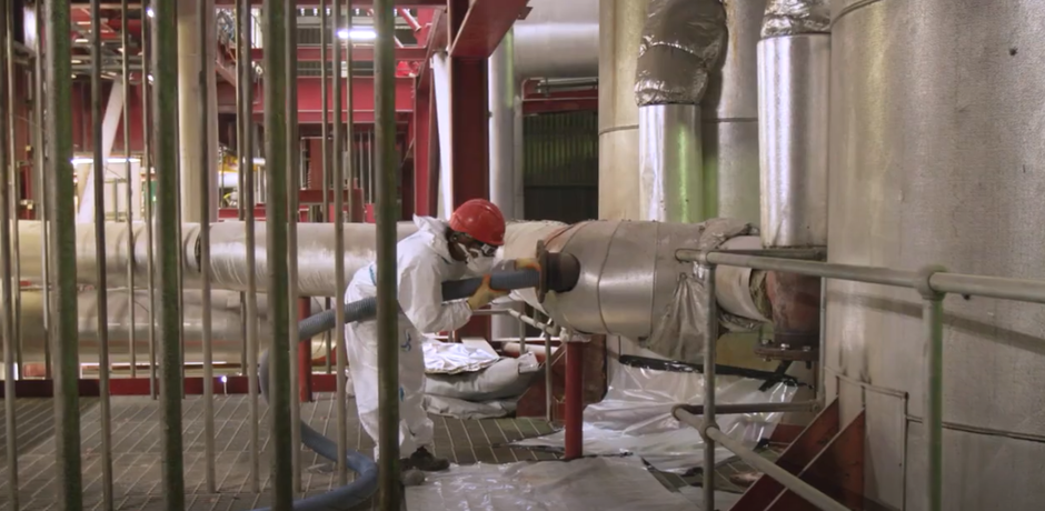 Veolia employee in white workwear and a red hardhat working on ERF services