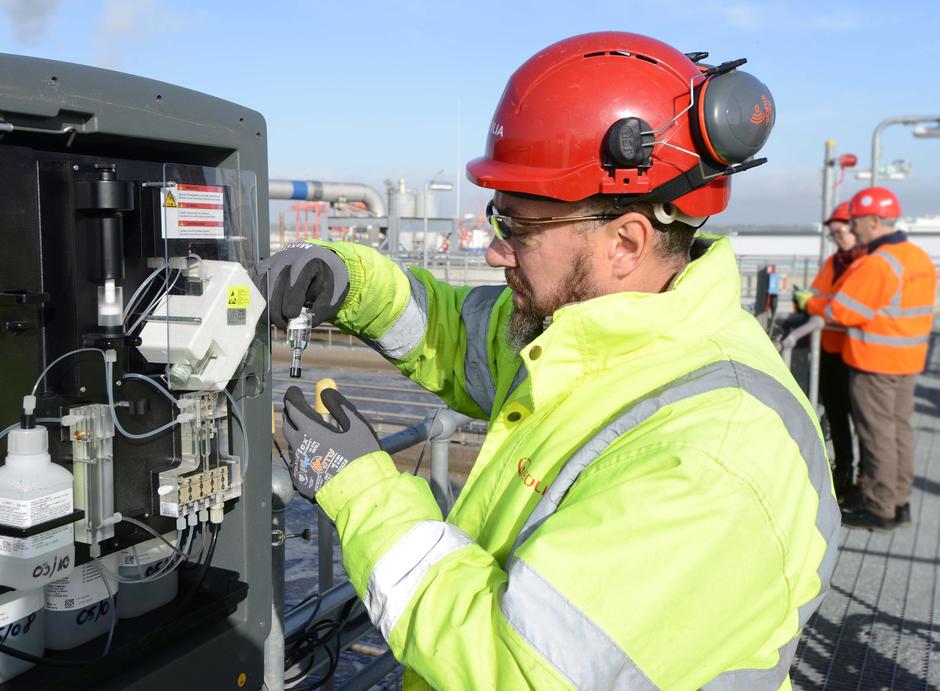 veolia worker wearing red hard hat and hi vis