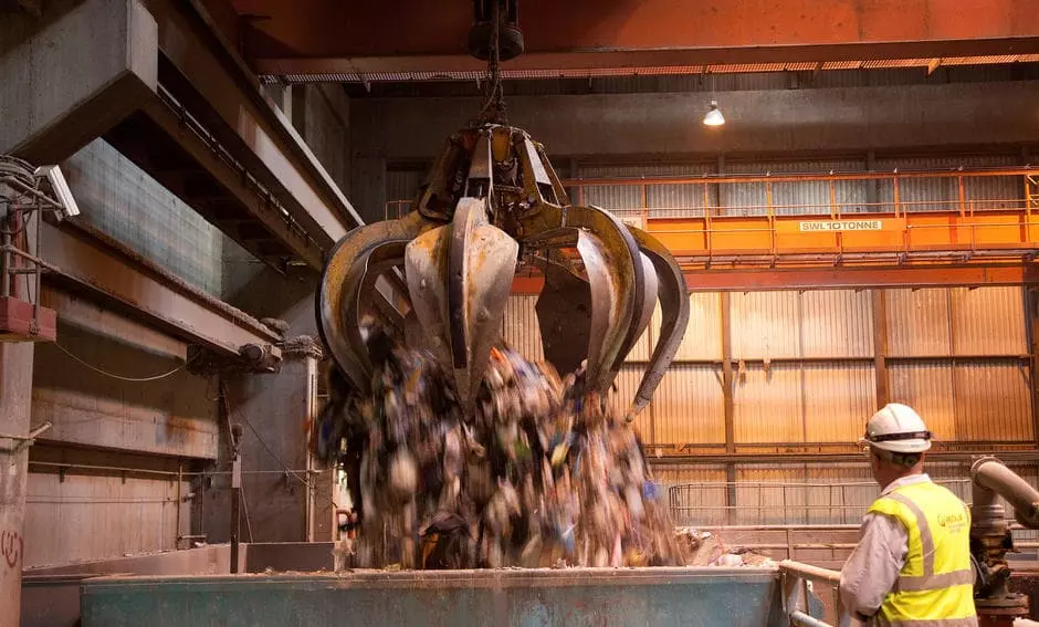 Large claw grabbing recycling waste