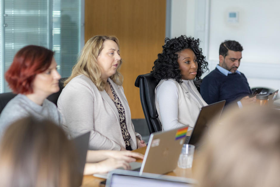 Diverse employees around meeting table