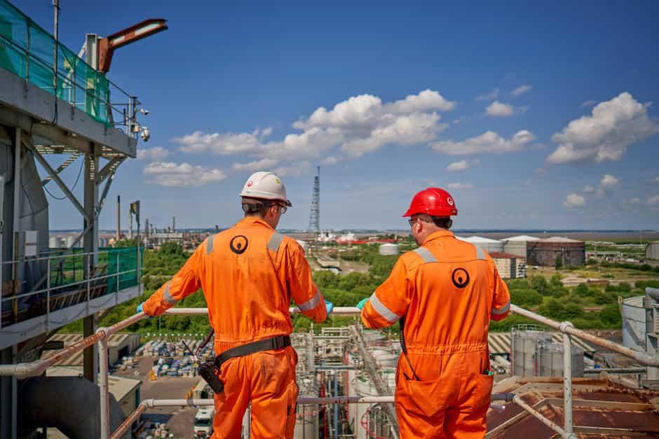 two workers looking over a work site 