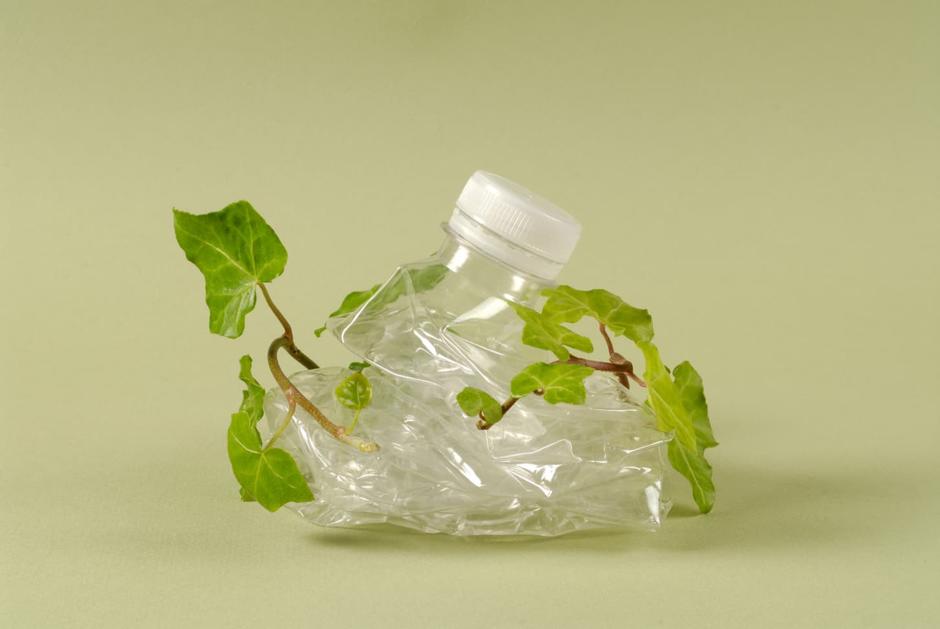 plastic bottle scrunched up with a green leaf tied around it 